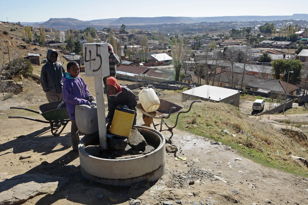children collecting water from outseide shared communal water well
