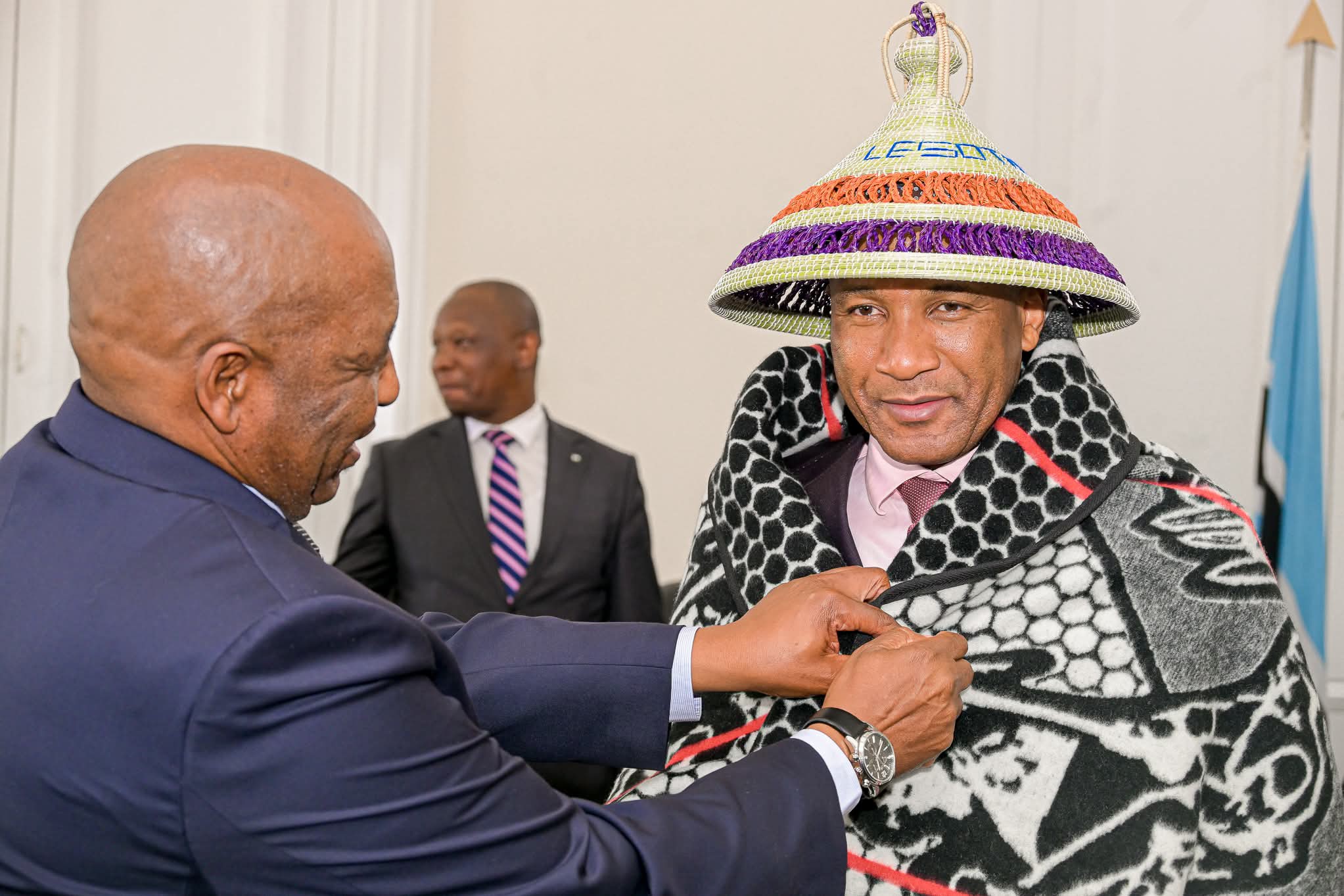 man in blanket and basotho hat fitting