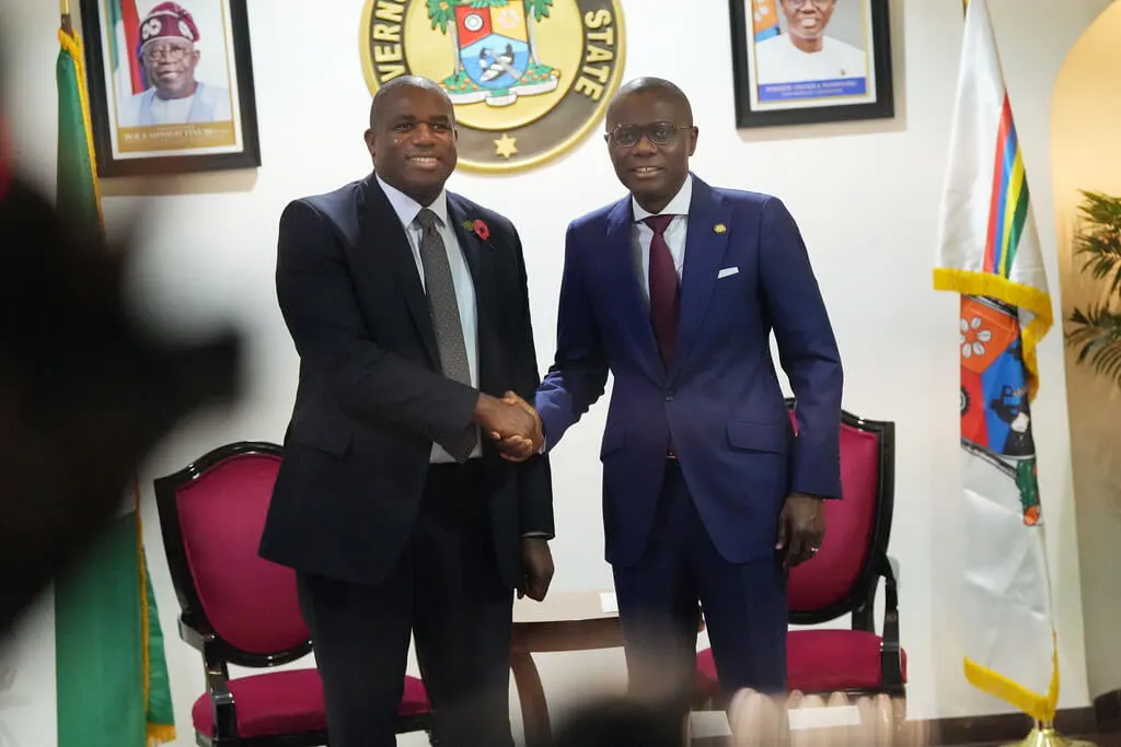 two suited men shaking hands in nigerian office