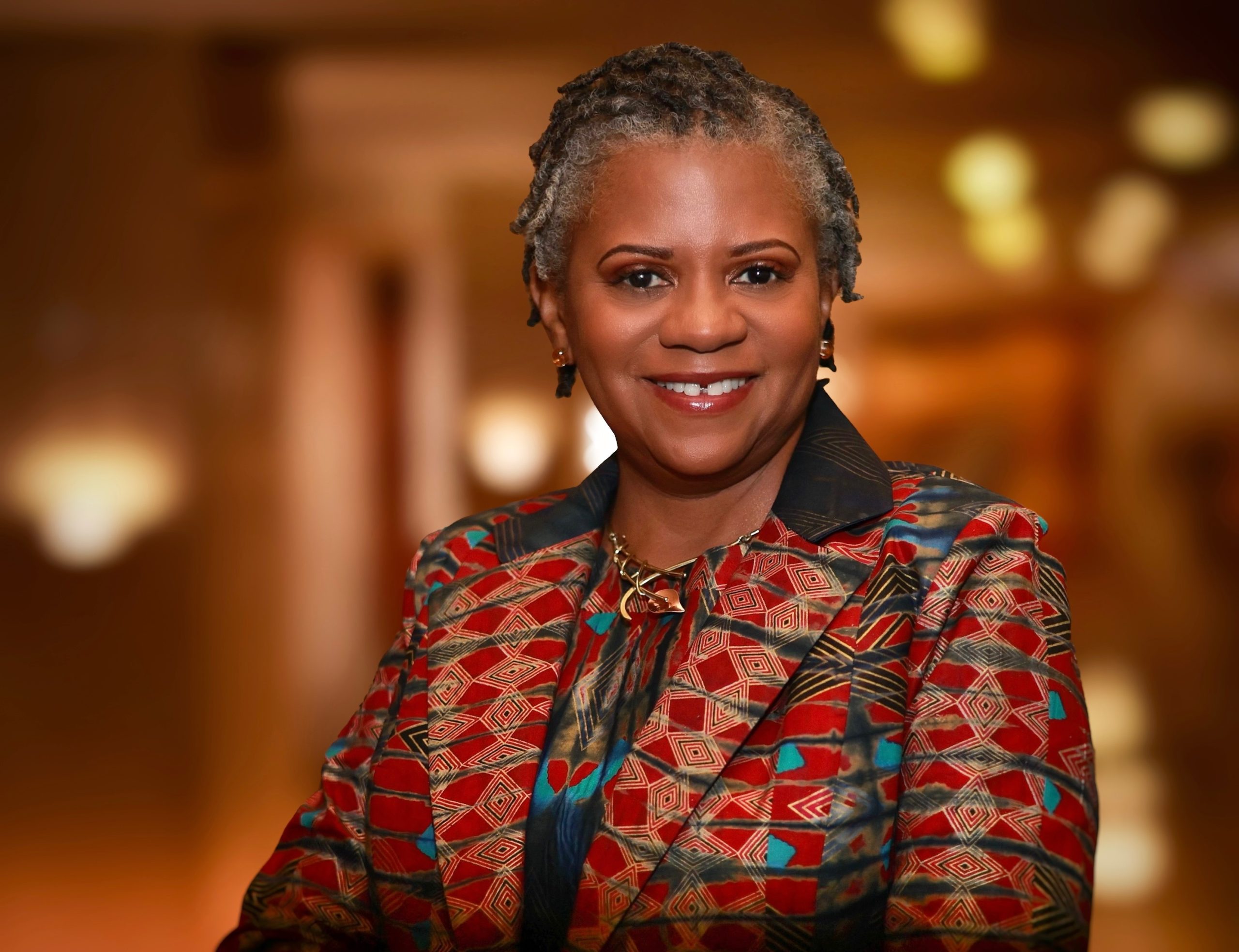 african lady in a kente cloth blazer