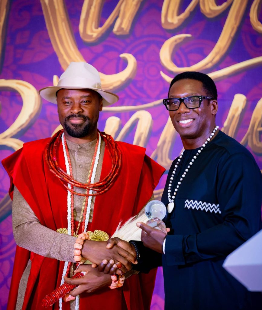 two african men in handshake and posing