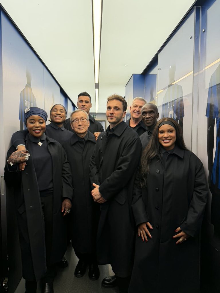 team dressed in black at winter olympics posing