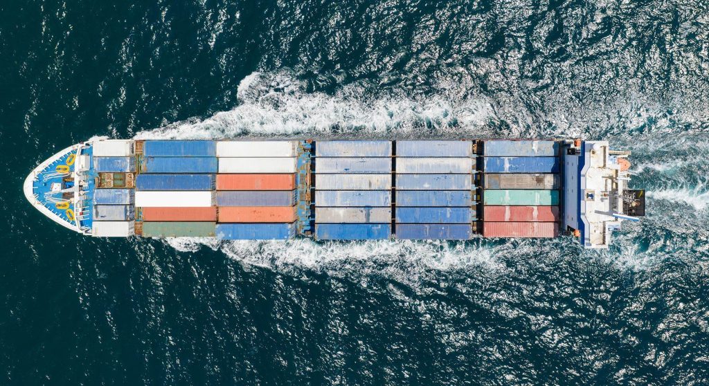 Aerial drone view of a modern container ship in transit, representing intra-African trade logistics and shipping efficiency.