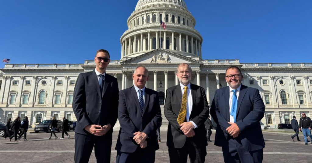 Leaders of AfriForum, the group behind the private prosecution of Julius Malema, standing in front of the U.S. Capitol, illustrating their international political agenda.
