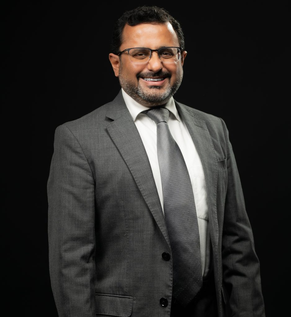 Saurav Chatterjee, Director and CEO of CareEdge Africa, wearing a grey suit and smiling in a professional headshot against a black background.