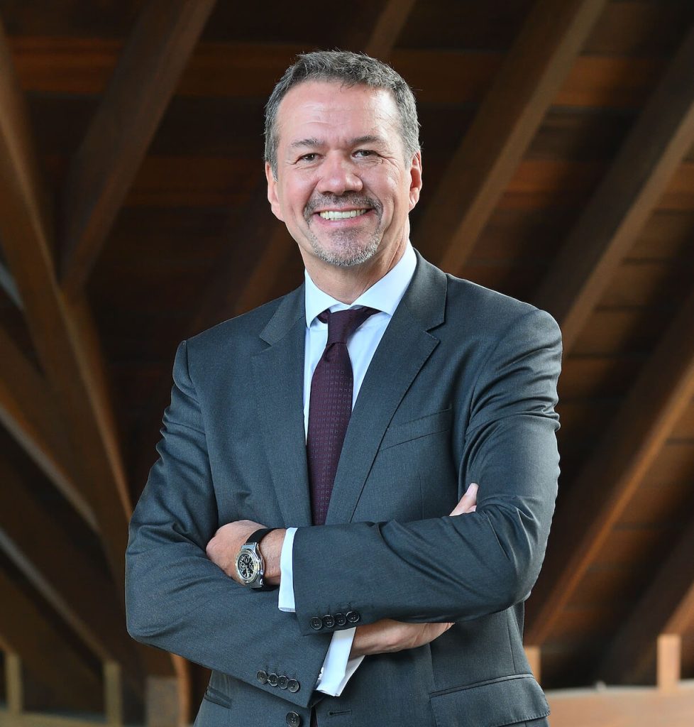 Thierry Hebraud, CEO of Mauritius Commercial Bank, smiling with arms crossed in a professional corporate suit.
