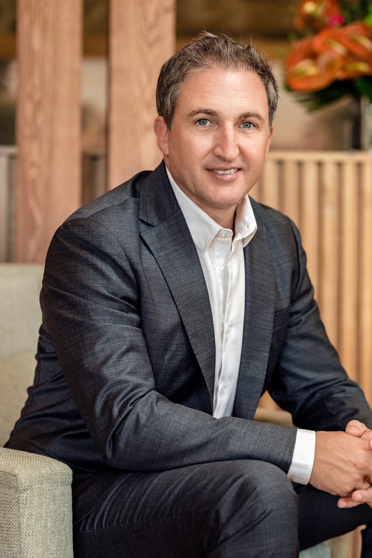Vincent Hardy, CEO of Mont Choisy Group, wearing a grey suit jacket and white shirt, sitting for a professional headshot in Mauritius.