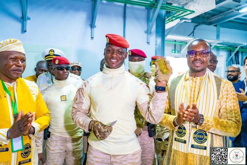 President of Burkina Faso, Captain Ibrahim Traoré holds a gold bar during the inauguration of the Raffinor-BF gold refinery in Ouagadougou.